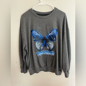 A long sleeve shirt from SHEIN with a butterfly Lettering says keep evolving.
